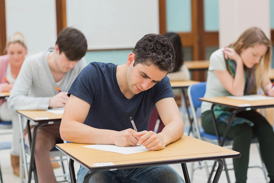 Students taking a test in a classroom in Pembroke